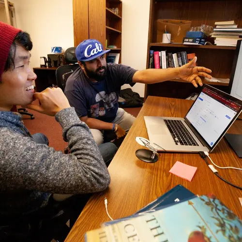 Mike Wong and colleague Anirudh Prabhu discuss how to tweak the presentation of a network of Earth's atmospheric chemistry in their shared office on the Broad Branch Road campus. 
