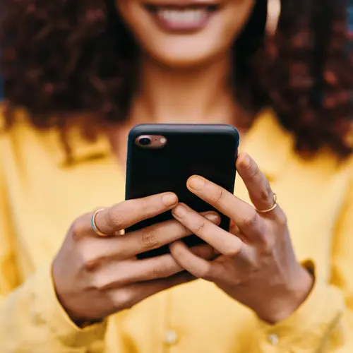 A woman checks her cell phone