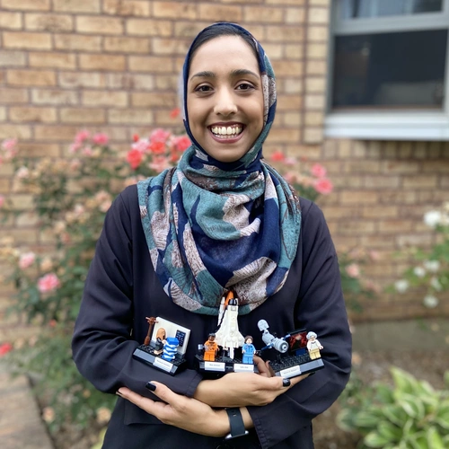 Munazza Alam poses with her Women of NASA Lego set that includes her astronomy role model Nancy Grace Roman, the "Mother of Hubble" in addition to astronauts Sally Ride and Mae Jemison and computer scientist Margaret Hamilton.