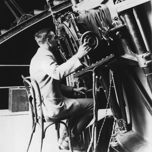Edwin Powell Hubble seated at the 100-inch reflecting telescope, Mount Wilson Observatory.