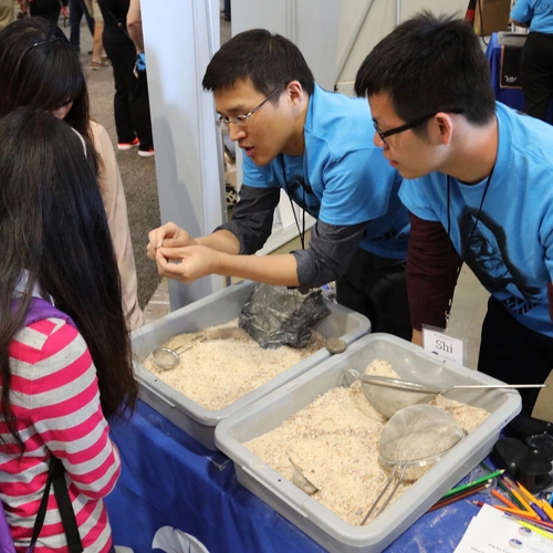 Attendees at the USA Science & Engineering Festival hunt for fossilized shark's teeth at the Carnegie booth