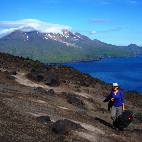 Diana Roman on the flank of the Cleveland volcano. Courtesy of Anna Barth of the University of California Berkeley. Photo taken under Alaska Maritime National Wildlife Refuge Research and Monitoring Special Use Permit #74500-16-009.