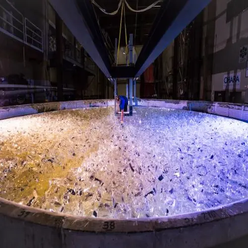 Mirror lab staff member places the last piece of glass into the mold for the fifth Giant Magellan Telescope mirror