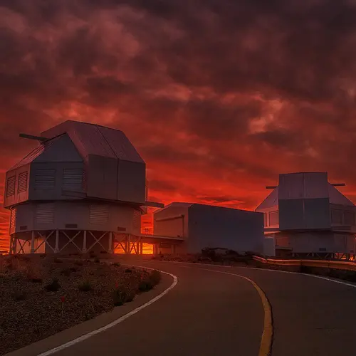 Sunset reddens the sky behind the Magellan telescopes at Carnegie's Las Campanas Observatory in Chile. 