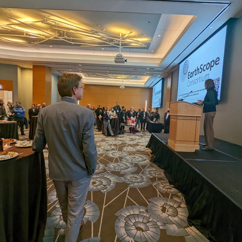 Lara Wagner stands at podium at EarthScope Reception