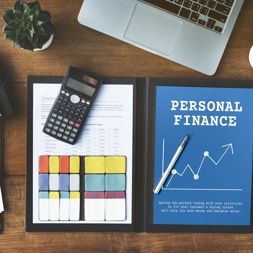 A tableau of personal finance monitoring, including charts, a laptop, a mobile phone, and a calculator.