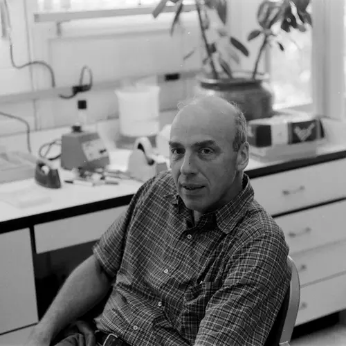 Donald Brown seated in the lab in Baltimore. Black and white photo. 