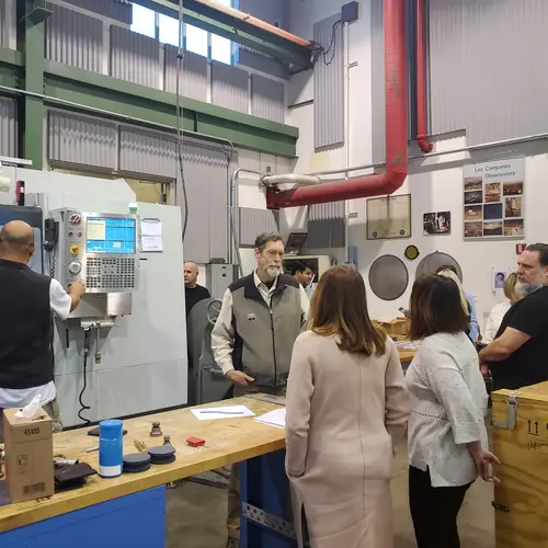 A tour group visits the Observatories machine shop