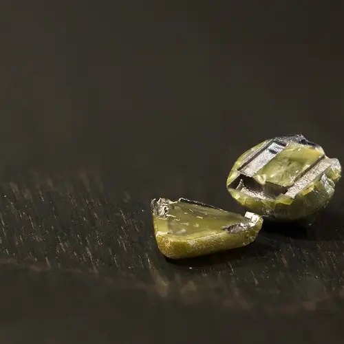 Close up of greenish-tinged diamonds from the lab