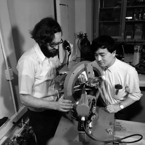 Larry Finger and Y. Ohashi aligning a crystal on the four-circle X-ray diffractometer in preparation for determining its structure