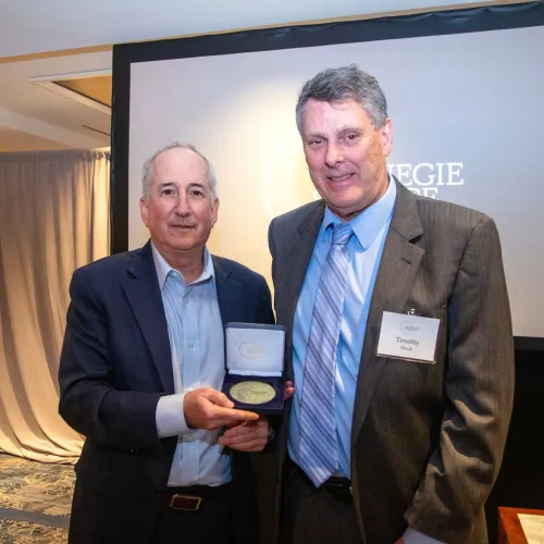 Carnegie Science President Eric Isaacs presents the Service to Science Award to Timothy Mock at the May 2024 Board of Trustees Dinner. 