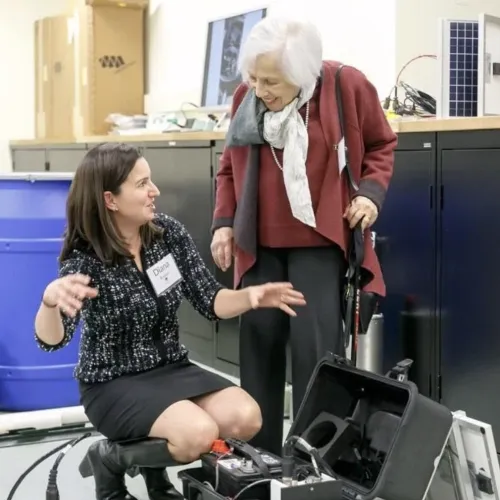 Diana Roman explains the quick deploy box to Maxine Singer during the May 2017 Trustees Meeting