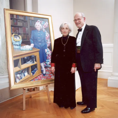 Maxine with her portrait and husband