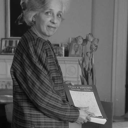 Carnegie president Maxine Singer with a copy of Genes and Genomes, the textbook she co-authored with Stanford's Paul Berg