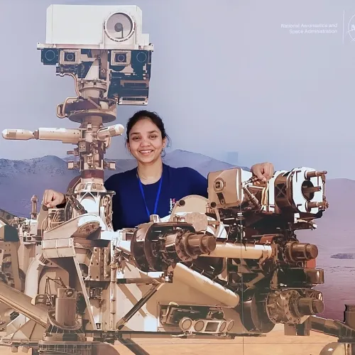 Anushree Srivastava poses with Mars rover mock ups