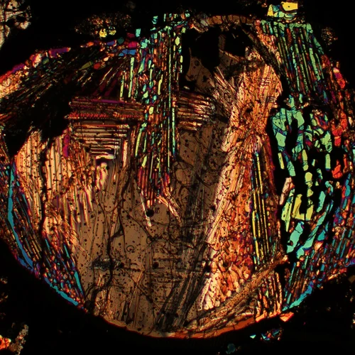 A thin meteorite section under a microscope.