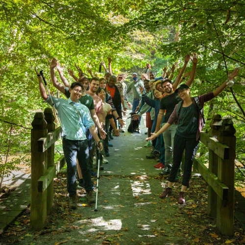 Postdocs pose on a bridge in Rock Creek PArk