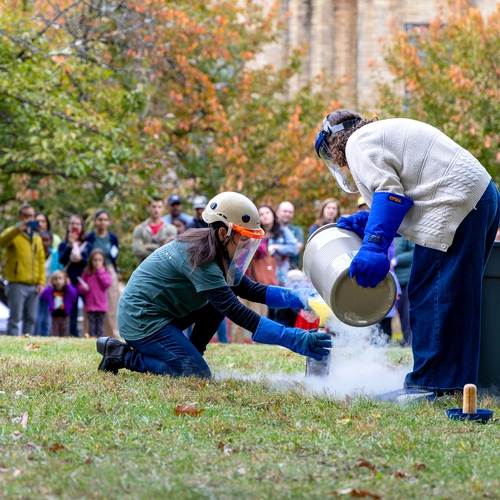 Diana Roman and Andrea Goltz prepare a "trash-cano" at the Earth & Planets Laboratory Open House.