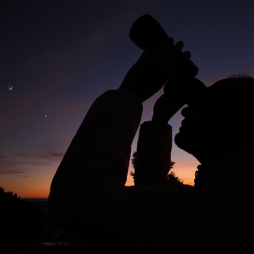 Stargazing with binoculars at sunset