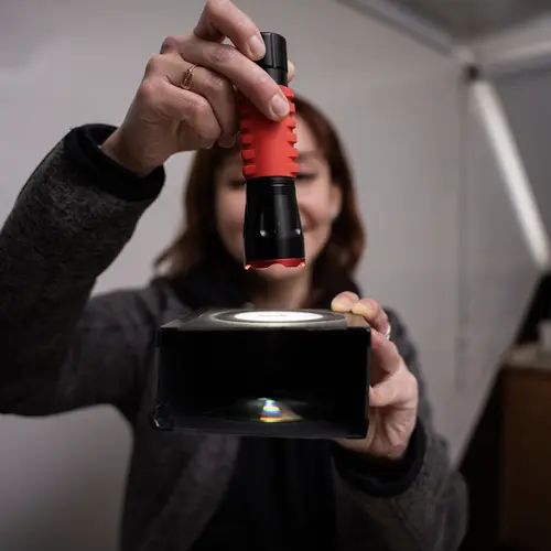 Carol Rojas demonstrates an astronomy concept during an outreach event